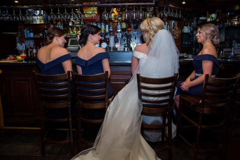 bride and bridesmaids enjoying drinks