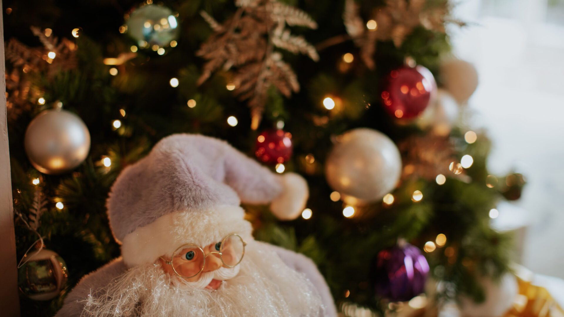 Christmas tree with sparkling lights and Santa ornament